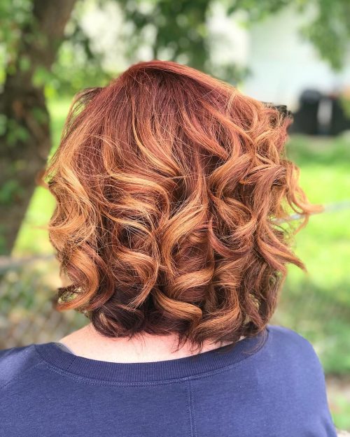 auburn curly hair with blonde highlights